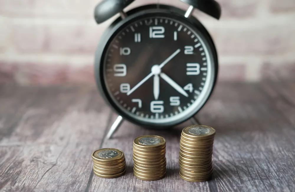 Clock and coins illustrating time and budget limits