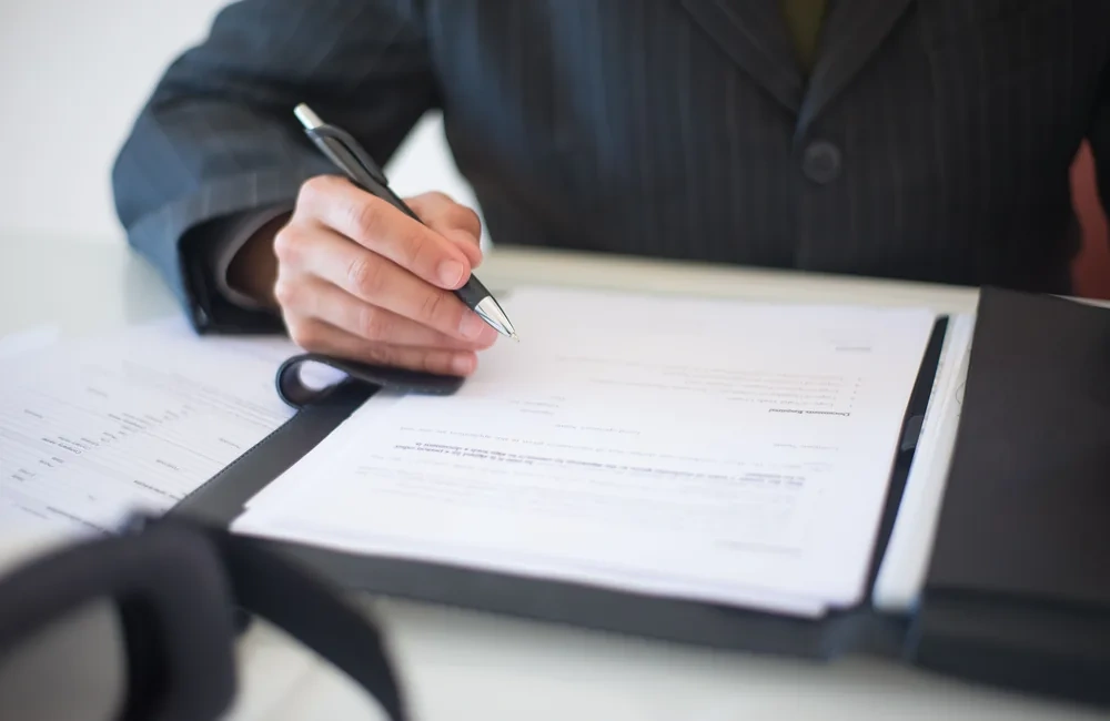 Contract signing scene for the bet3k terms and conditions